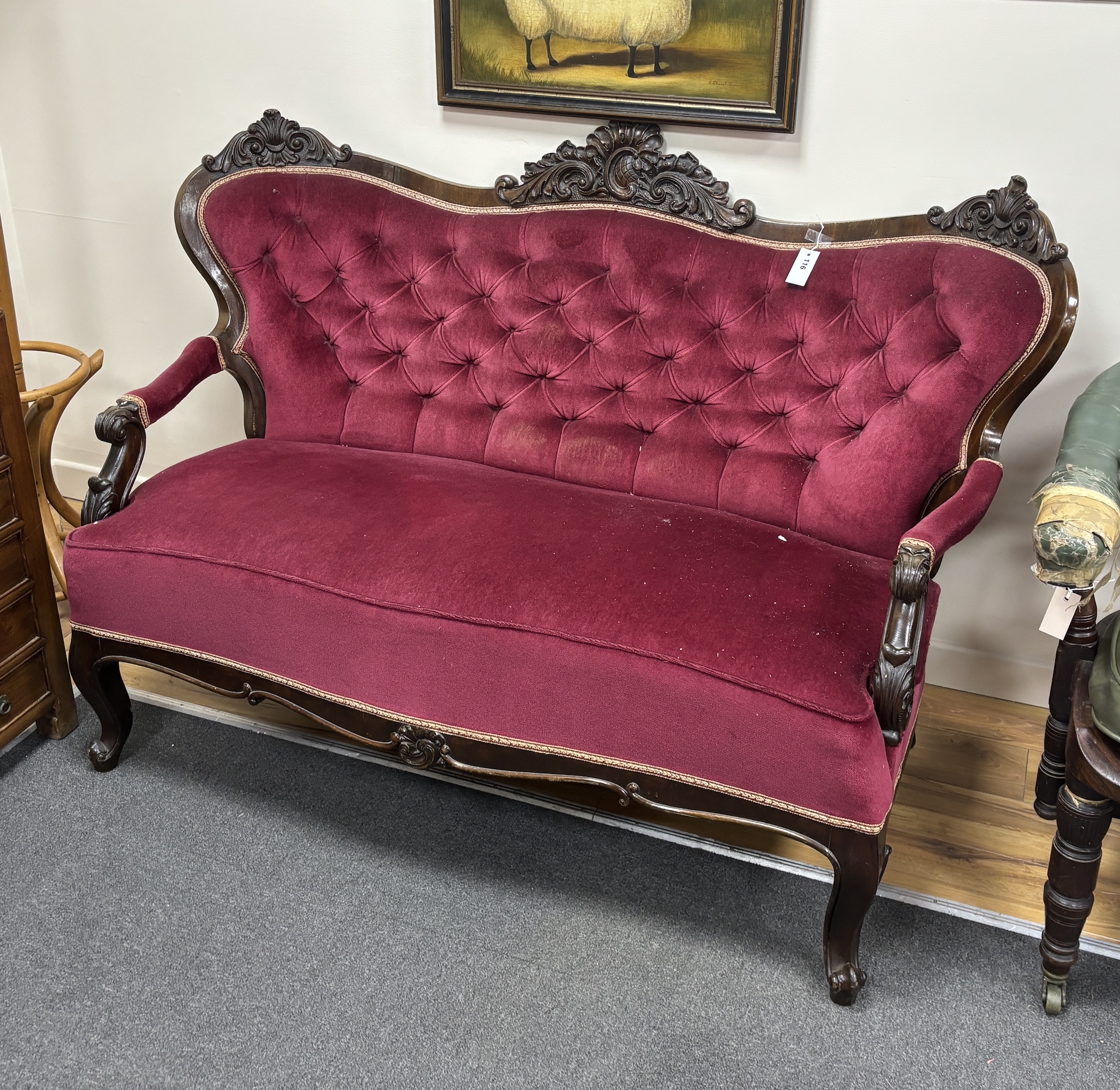 A late 19th century Austro-Hungarian carved mahogany settee with buttoned burgundy upholstery, length 162cm, width 85cm, height 112cm